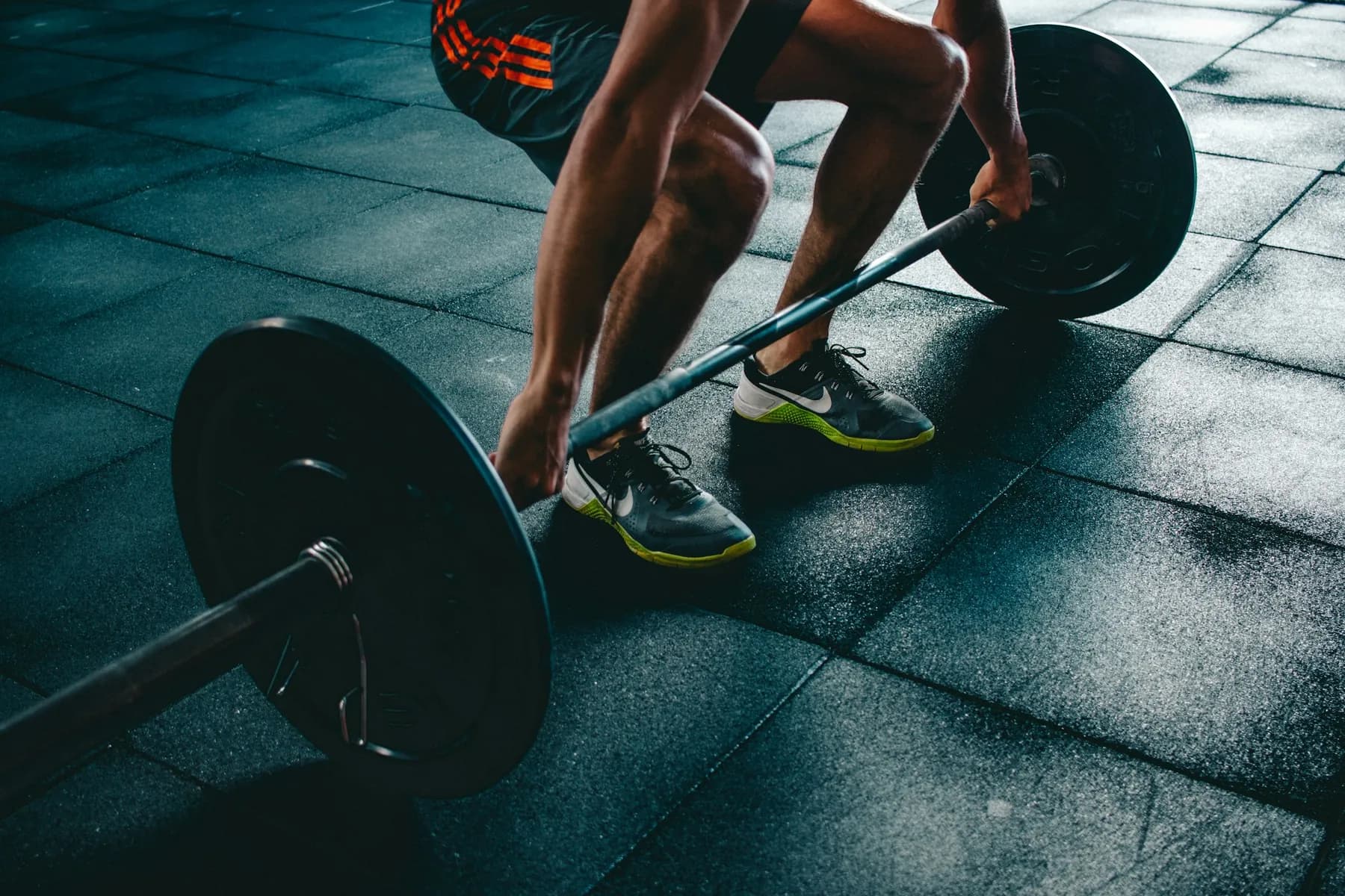 A barbell deadlift in a dark gym