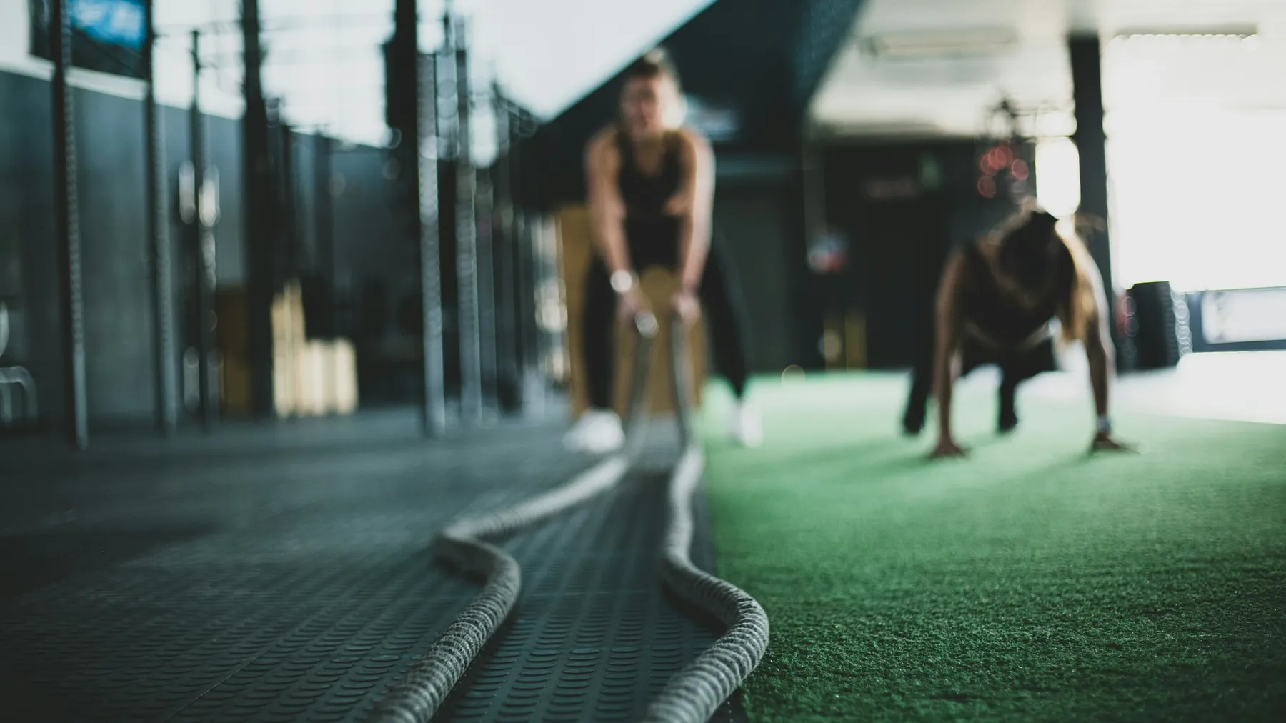 Two people training with battle ropes